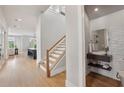 Bright entryway with open staircase, hardwood floors and modern powder room at 6815 Halcyon Way, Alpharetta, GA 30005