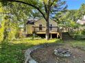 Cozy home with a wooden deck, stone firepit, and spacious yard, perfect for outdoor living at 1238 Trenton St, Atlanta, GA 30316