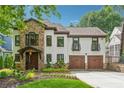 Charming two-story home with a stone accent wall, white stucco, and a well-manicured lawn at 1352 Middlesex Ne Ave, Atlanta, GA 30306