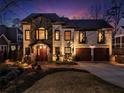 Elegant two-story home with stone and stucco exterior, accentuated by manicured landscaping and a cozy front entry at 1352 Middlesex Ne Ave, Atlanta, GA 30306
