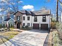Attractive home featuring a combination of stone and stucco exterior, a well-kept lawn, and a spacious driveway at 1352 Middlesex Ne Ave, Atlanta, GA 30306