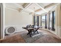 Elegant dining room featuring coffered ceiling, wainscoting, and a stylish chandelier at 1417 Sterlingbrooke Dr, Powder Springs, GA 30127