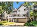 Rear exterior with a large deck, garage, and well-manicured yard at 2356 Defoors Ferry Nw Rd, Atlanta, GA 30318