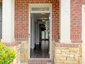 Inviting entryway with wood floors, brick columns, and a view into the home at 3062 Hawthorn Farm Blvd, Loganville, GA 30052