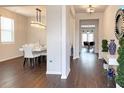 View of a hallway with elegant lighting that opens to the dining and living areas at 3062 Hawthorn Farm Blvd, Loganville, GA 30052