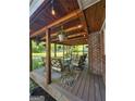 Inviting covered back porch with outdoor seating, decorative lighting, and wood-paneled ceiling, perfect for relaxing outdoors at 4715 Howard Dr, Powder Springs, GA 30127