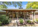 Charming covered back porch featuring a seating area, potted plants, and decorative wooden posts at 4715 Howard Dr, Powder Springs, GA 30127