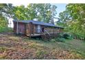 A classic brick house with a wooden back deck surrounded by a lush, wooded yard at 1512 Pine Cir, Lawrenceville, GA 30044
