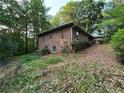 A traditional brick home is nestled in a lush landscape with mature trees at 1512 Pine Cir, Lawrenceville, GA 30044