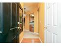Bright foyer showcasing warm wall colors, wood flooring, and views into the kitchen and living areas at 1640 Donovans Nw Rdg, Kennesaw, GA 30152