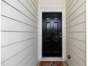 Welcoming front door with a modern black finish and a traditional design, set against neutral siding at 1640 Donovans Nw Rdg, Kennesaw, GA 30152