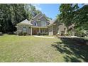 Charming two-story brick home with manicured lawn and inviting walkway, offers a warm and welcoming curb appeal at 375 Beracah Tr Southwest Sw Trl, Atlanta, GA 30331
