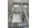Close-up on a double vanity with granite countertop and rectangular sinks at 2837 Lakewater Way, Snellville, GA 30039