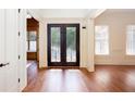 Light-filled foyer with hardwood floors and front door at 3333 N Hembree Rd, Marietta, GA 30062