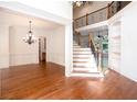 Bright foyer with staircase, dark hardwood floors, and chandelier at 3333 N Hembree Rd, Marietta, GA 30062