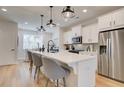 A modern kitchen with a large island, stainless steel appliances, and elegant pendant lighting at 3352 Cranston Ln, Kennesaw, GA 30144
