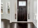 Elegant foyer featuring dark hardwood floors, white trim, and natural light at 4171 Towncastle Ln, Buford, GA 30518