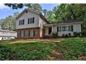 Two story home featuring a brick facade and light gray siding with well maintained landscaping at 752 Roxboro Trce, Lawrenceville, GA 30044