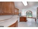 Open concept kitchen features wood cabinets, tiled floor, and views to the dining area at 98 Country Acres Ct, Mcdonough, GA 30253