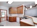 Eat-in kitchen with bar, pendant lights, neutral countertops and wooden cabinets at 98 Country Acres Ct, Mcdonough, GA 30253
