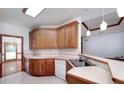 Kitchen boasts wood cabinets, white countertops, and stainless steel sink at 98 Country Acres Ct, Mcdonough, GA 30253