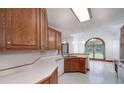 Bright kitchen featuring wood cabinets, skylight, and open view to the dining area at 98 Country Acres Ct, Mcdonough, GA 30253