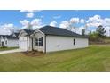 A single-story home with an attached garage surrounded by a well-maintained lawn at 1626 Palladian Way, Lithonia, GA 30058