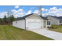 Well-maintained single-story home with an attached garage and lush green lawn at 1626 Palladian Way, Lithonia, GA 30058