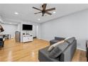 Cozy living room with hardwood floors, gray sofa, and a television mounted on the wall at 6851 Roswell Rd # E4, Atlanta, GA 30328