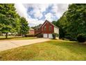 Spacious two-story home with a two-car garage and mature trees in a landscaped yard at 1045 Paper Creek Dr, Lawrenceville, GA 30046