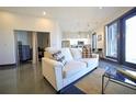 Modern living room featuring a comfortable couch, polished floors and a view into the bright kitchen at 1195 Milton Se Ter # 1109, Atlanta, GA 30315