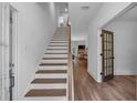 Inviting hallway with hardwood floors leading to a staircase and living area at 135 Old Alabama Rd, Emerson, GA 30137