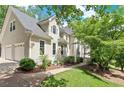 Elegant home with a charming stucco exterior, complemented by an attached two-car garage and verdant lawn at 4223 N Mountain Ne Rd, Marietta, GA 30066