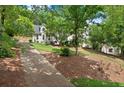 Traditional two story home with a manicured front lawn, mature trees, and a private drive in a serene setting at 4223 N Mountain Ne Rd, Marietta, GA 30066