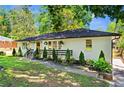 Single-story home showcasing a well-manicured lawn, white-painted brick, and tastefully landscaped front yard at 1790 Shirley Sw St, Atlanta, GA 30310