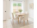 Cozy dining area with a round table, comfortable seating, and natural light from the sliding glass doors at 191 Northdale Pl, Lawrenceville, GA 30046