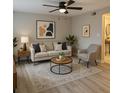 Bright living room featuring stylish decor, a ceiling fan, and modern flooring at 191 Northdale Pl, Lawrenceville, GA 30046