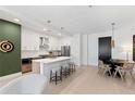 Modern kitchen featuring a quartz island with seating, stainless steel appliances, and a dining area with contemporary decor at 775 Juniper St # 212, Atlanta, GA 30308