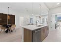 Well-lit kitchen with a large island and dining area with contemporary decor and stainless steel appliances at 775 Juniper St # 212, Atlanta, GA 30308