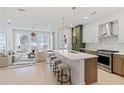 Open-concept kitchen and living room with stainless steel appliances, a quartz countertop island, and modern furnishings at 775 Juniper St # 212, Atlanta, GA 30308