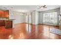 Bright, open-concept living space featuring wood floors, updated appliances, a ceiling fan, and large windows at 1199 Lavista Ne Rd, Atlanta, GA 30324