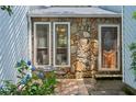 A close-up of the house's entrance, which includes a stone facade, a glass door, and an outdoor seating space at 3299 Pete Shaw Rd, Marietta, GA 30066