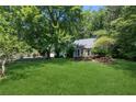 A well-manicured lawn and mature trees surround this attractive single-story home at 3299 Pete Shaw Rd, Marietta, GA 30066