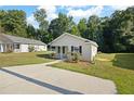 Inviting single-story home with a well-manicured lawn, concrete driveway, and mature trees at 3645 Ten Oaks Cir, Powder Springs, GA 30127