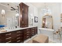 Luxurious bathroom featuring double vanities, soaking tub, elegant fixtures, and a chandelier at 4905 Village Green Dr, Roswell, GA 30075