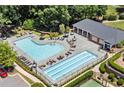 Aerial view of community pool with lounge chairs and clubhouse at 4905 Village Green Dr, Roswell, GA 30075