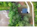 Aerial view of a charming home with a pond and beautiful landscaping at 115 Haven Brook Way, Douglasville, GA 30134