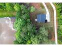 Areal view of new home surrounded by lush greenery, pond and long driveway at 115 Haven Brook Way, Douglasville, GA 30134