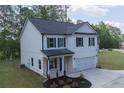 Lovely home with white siding, black shutters, a manicured lawn and attached two car garage at 115 Haven Brook Way, Douglasville, GA 30134