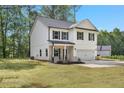 Side view of a two-story home featuring white siding, black shutters, and a well-maintained lawn at 115 Haven Brook Way, Douglasville, GA 30134
